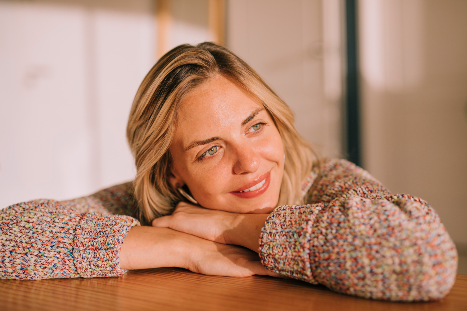 Smiling woman resting on her arms